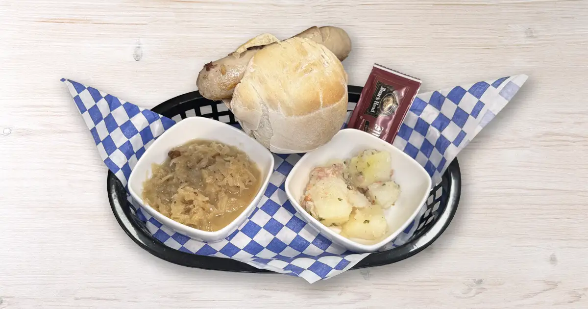 Bratwurst on brochten with sides of potatoes and saurrkraut Bratwurst on brochten with sides of potatoes and saurrkraut